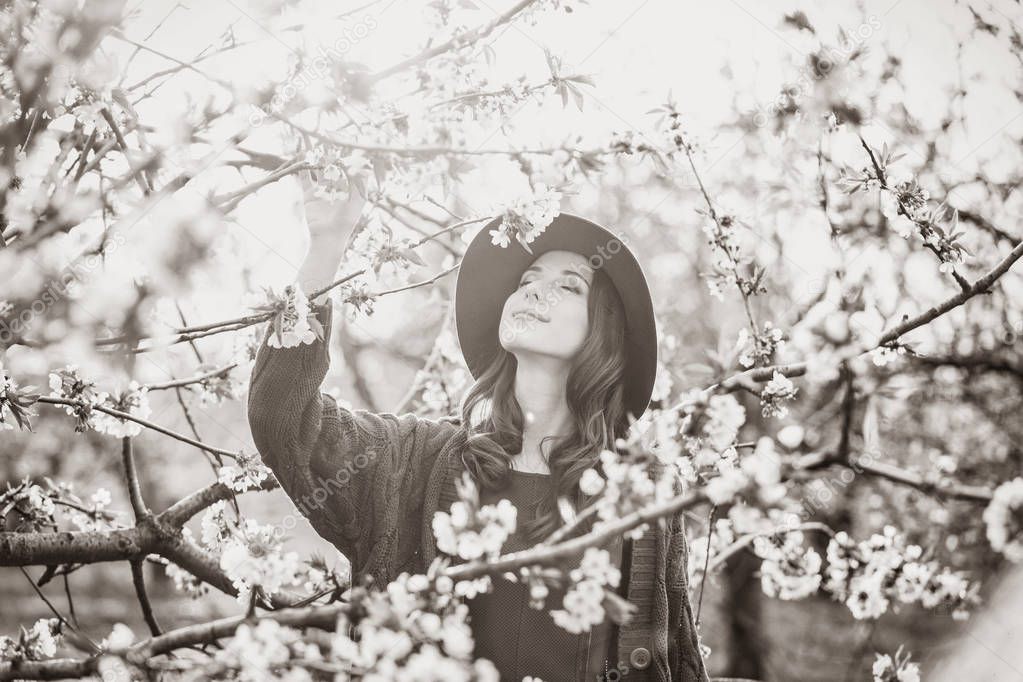 woman in blossom apple tree garden