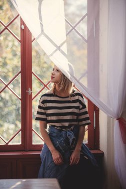 Genç kız kalın yakınındaki eski saray penceresinde. Sonbahar sezonu sahne 