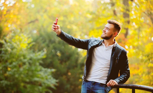 Young White Guy Using Mobile Phone Camera Selfie Park Yellow — Stock Photo, Image