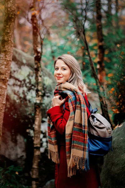 在森林与岩石的围巾和大衣漂亮的年轻妇女 在山的秋季季节时间 — 图库照片