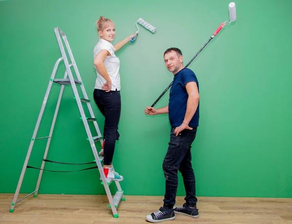 Young Family Painting Wall Green Color Using Roller Painters New — Stock Photo, Image