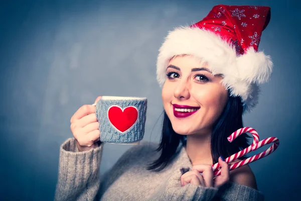 Woman with cup and lollipop — Stock Photo, Image