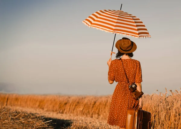 Genç kadın ile bavul, şemsiye ve fotoğraf makinesi — Stok fotoğraf