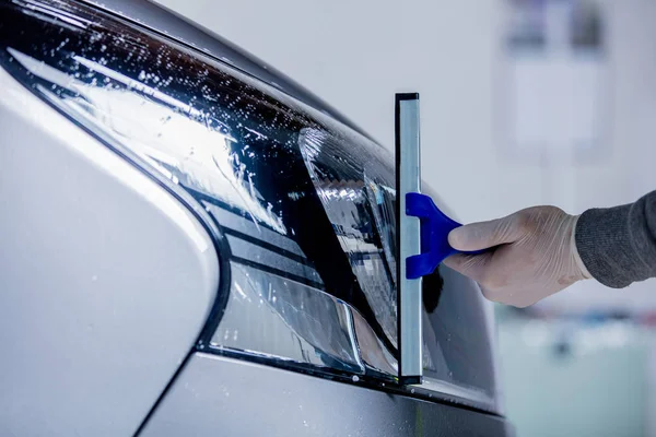 Washing a car headlight on carwash — Stock Photo, Image