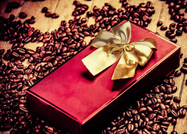 Red gift on wooden table — Stock Photo, Image