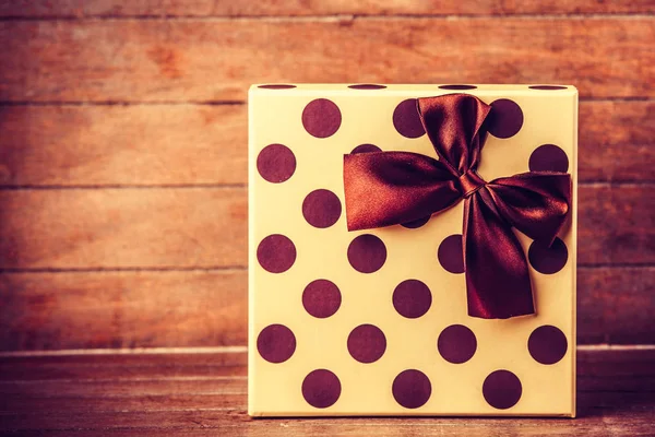 Christmas box with polka dots with a bow — Stock Photo, Image