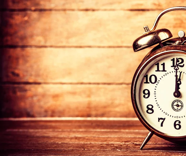 Gray metal alarm clock on a wooden table — Stock Photo, Image