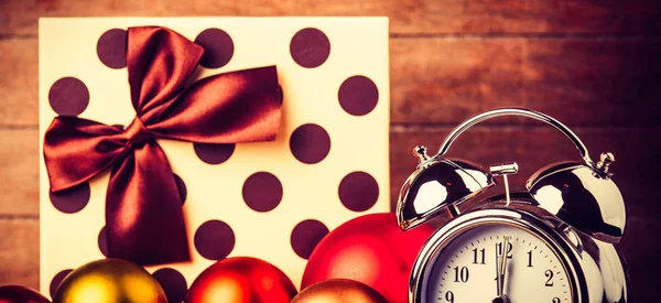 Gray metal alarm clock and Christmas gifts — Stock Photo, Image