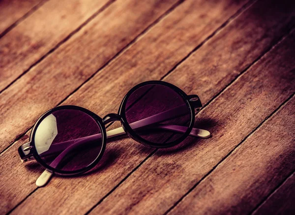 Retro sunglasses on wooden table — Stock Photo, Image