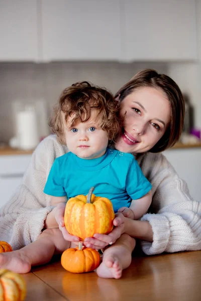 Happy mother and son with pumpkin. — Stock Photo, Image