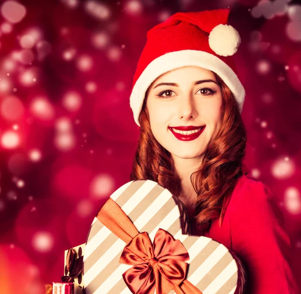 Woman in red dress with Christmas gift box — Stock Photo, Image