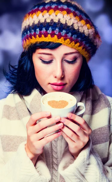 Girl in beret and scarf holding cup of coffee — Stock Photo, Image