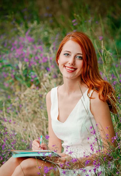 Style redhead girl in white dress with notebook — Stock Photo, Image