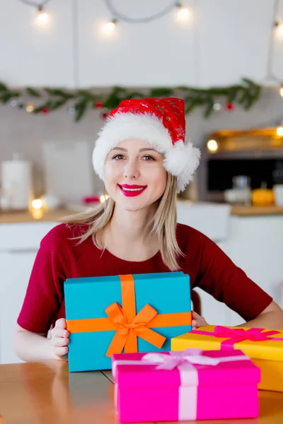 Chica en sombrero de Navidad con cajas de regalo —  Fotos de Stock
