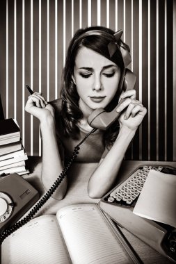 secretary near the typewriter and dial phone clipart