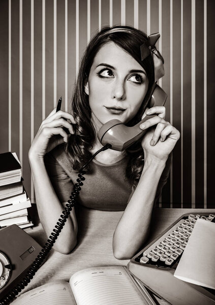 secretary near the typewriter and dial phone