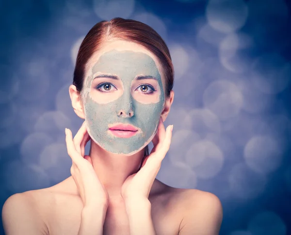 Young redhead woman with cosmetic cream — Stock Photo, Image