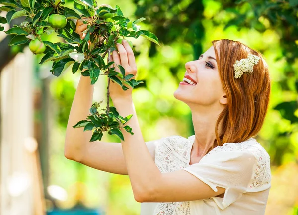 Dívka v bílých šatech zůstat šťastný u jabloní — Stock fotografie