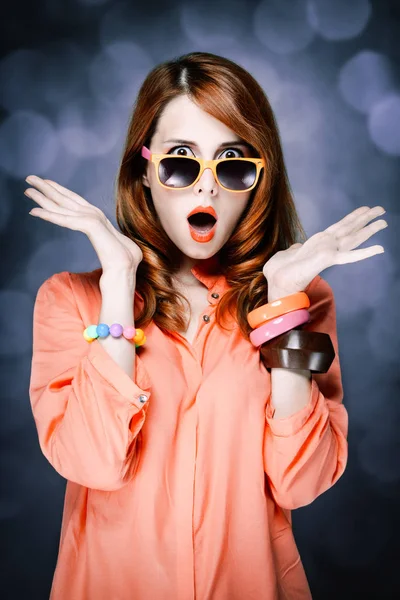 Förvånad rödhårig flicka i solglasögon — Stockfoto
