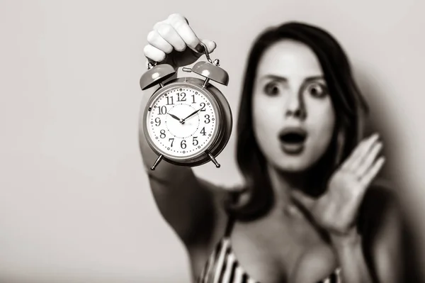 保持している若い女性は、目覚まし時計を高齢者. — ストック写真
