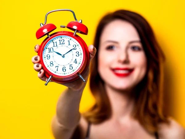 Woman holding aged red alarm clock — Stock Photo, Image