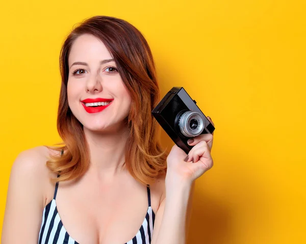 Smiling woman with camera — Stock Photo, Image