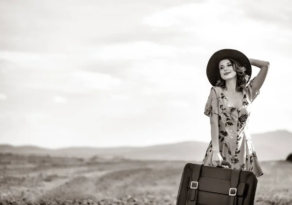 Woman at countryside with suitcase — Stock Photo, Image