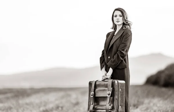 Woman at countryside with suitcase — Stock Photo, Image