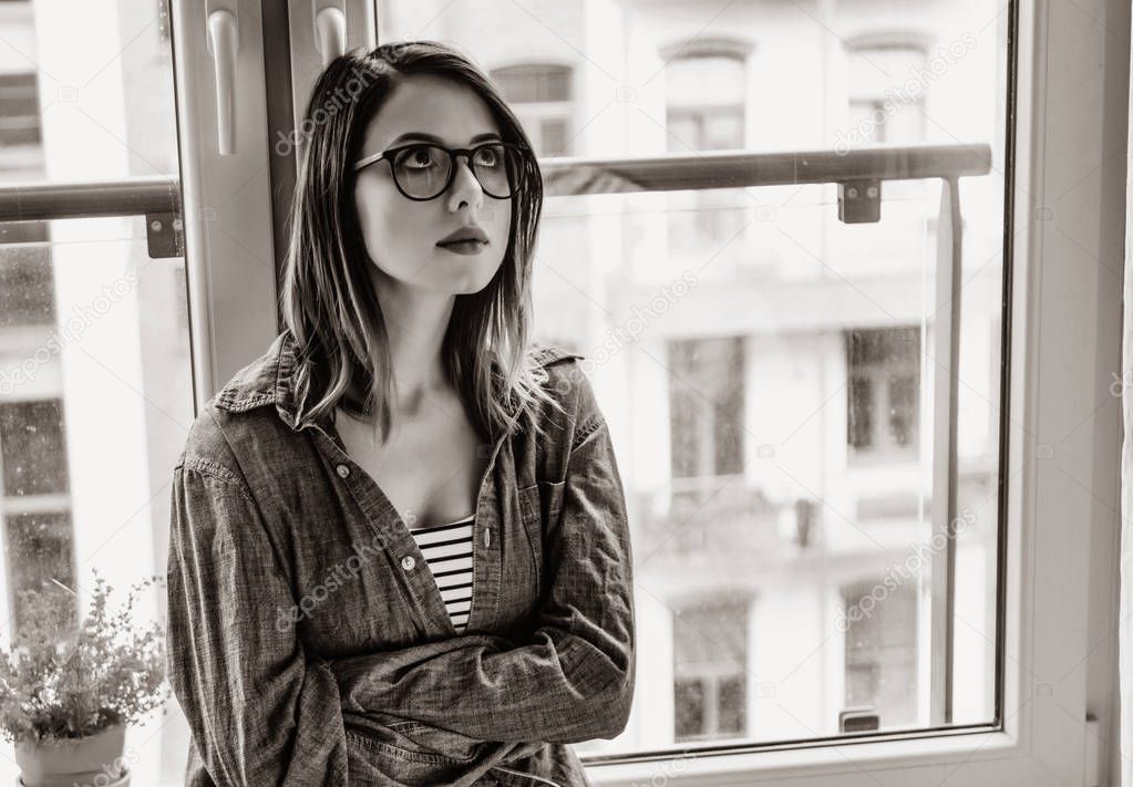 portrait of beautiful thoughtful young woman in glasses