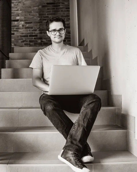 Handsome young freelancer man using laptop computer — Stock Photo, Image