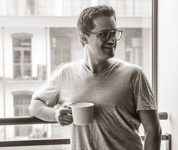 Handsome young freelancer man with cup of coffee — Stock Photo, Image