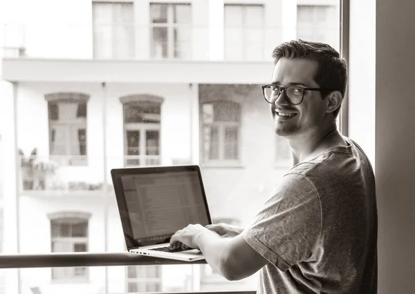 Handsome young freelancer man using laptop computer — Stock Photo, Image