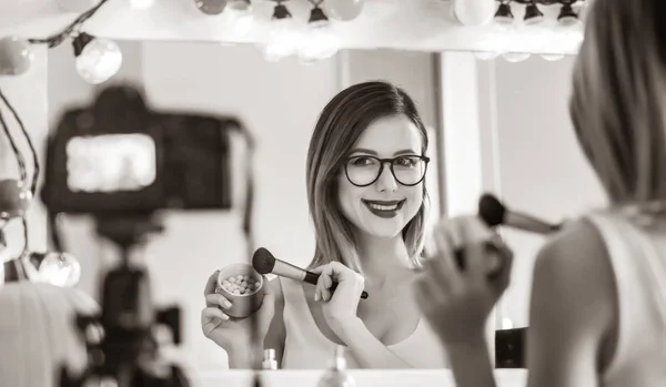 Blogger vrouw toepassen van cosmetica op camera — Stockfoto