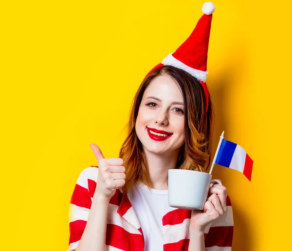 Woman in Santa Claus hat with France flag and cup — Stock Photo, Image