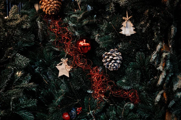 Oyuncaklar ve çam kozalakları dekorasyon Noel ağacı üzerinde — Stok fotoğraf
