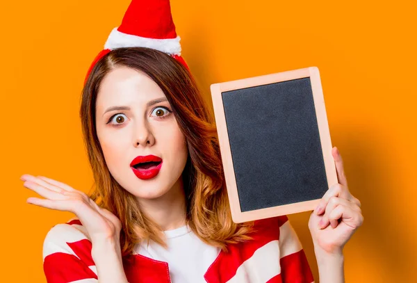 Woman in Santa Claus hat with blackboard — Stock Photo, Image