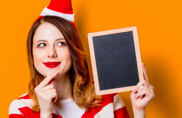 Woman in Santa Claus hat with blackboard — Stock Photo, Image