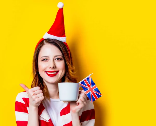 Woman in Santa Claus hat with GB flag and cup — Stock Photo, Image