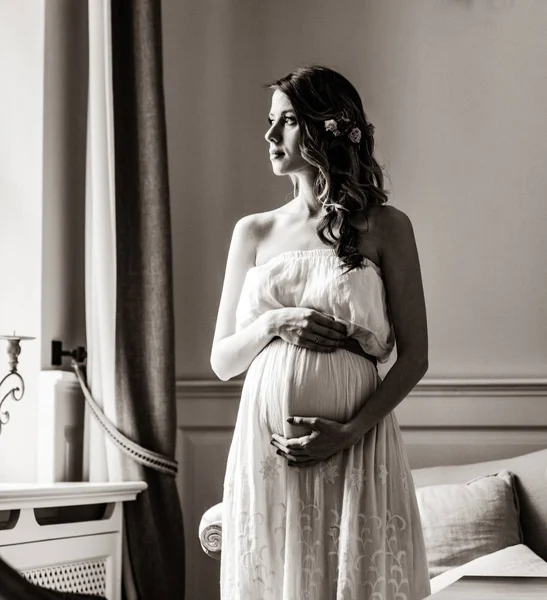 Jeune femme enceinte en robe blanche — Photo