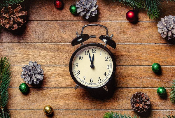 Christmas decoration and little alarm clock near pine branch — Stock Photo, Image