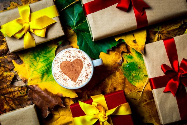 Cup of cappuccino with heart shape on maple leaves — Stock Photo, Image