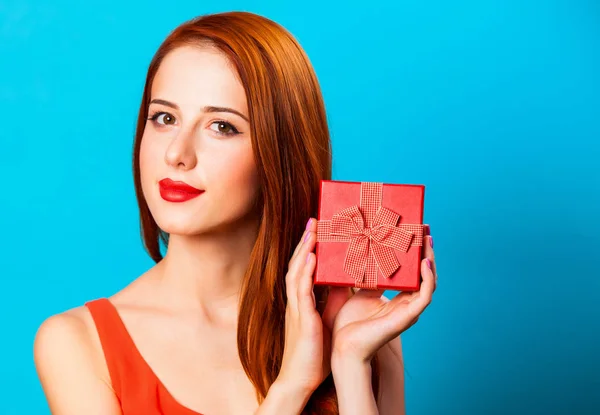 Femme Rousse Souriante Avec Cadeau Sur Fond Bleu — Photo