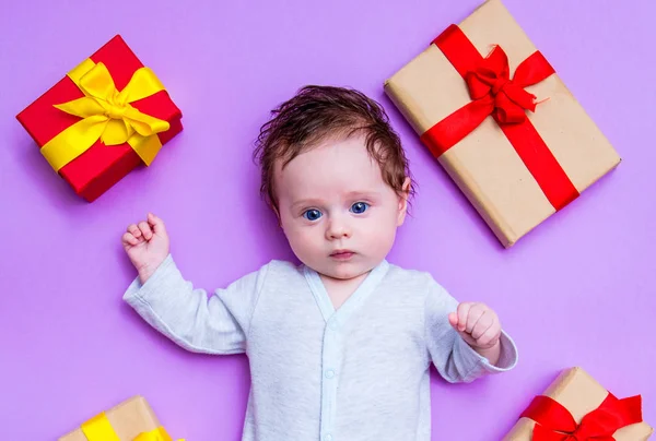 Little baby with holiday gifts — Stock Photo, Image