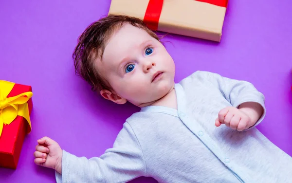 Little baby with holiday gifts — Stock Photo, Image