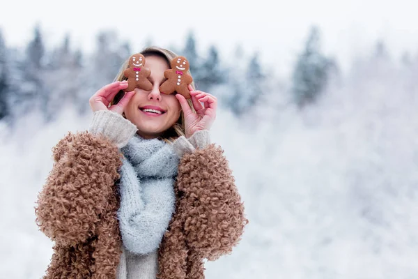 Vacker flicka i rock med kaka i en snöskog — Stockfoto