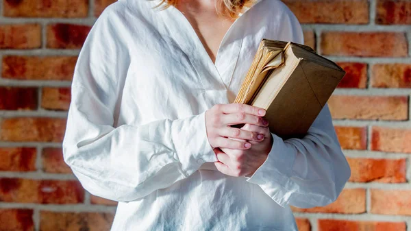 Mujer Camisa Blanca Sosteniendo Libro Viejo Sobre Fondo Pared Ladrillo — Foto de Stock