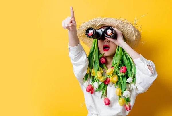 Woman with springtime tulips instead hair and bonocular — Stock Photo, Image