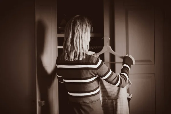 Young girl choose a dress at home near wardrobe — Stock Photo, Image