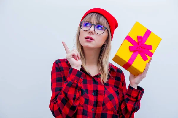 Mujer en camisa roja y sombrero sosteniendo caja de regalo de vacaciones — Foto de Stock