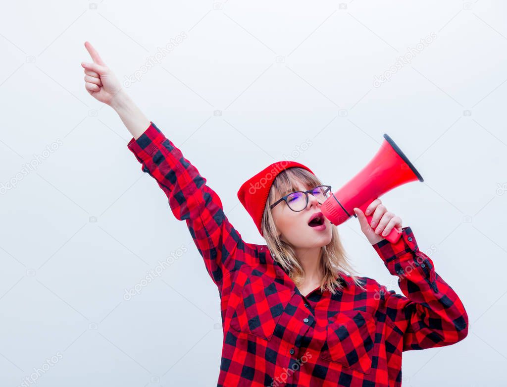 woman in red shirt and hat with loud shout with megaphone